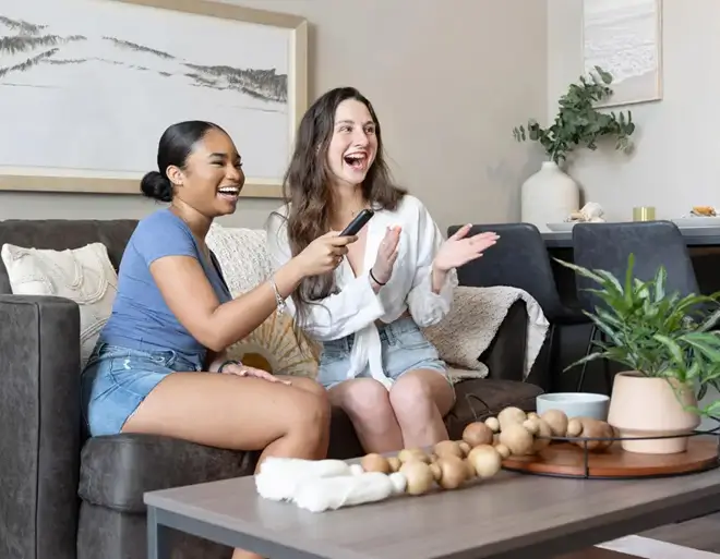 two young women watching tv
